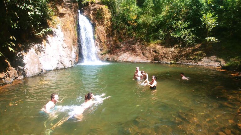 Riders swimming in the natural pool below Sutton Waterfall