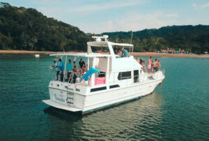 A Jaco party boat excursion near the Jaco Beach shoreline in Costa Rica