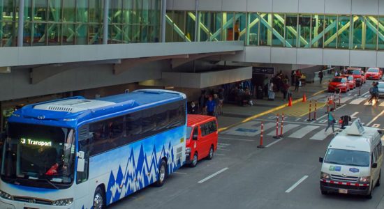 Drone view of San Jose Airport in Costa Rica and transportation vans and buses going to Jaco Beach